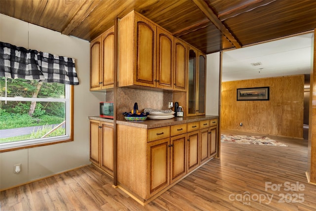 kitchen featuring decorative backsplash, wood ceiling, and light hardwood / wood-style flooring