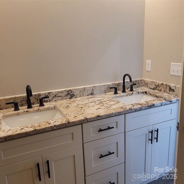 bathroom featuring double vanity and a sink