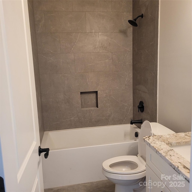 bathroom featuring toilet, vanity, and bathtub / shower combination