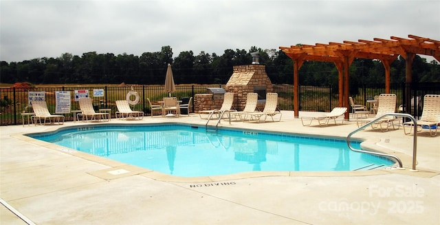 community pool with a patio area, a fireplace, a pergola, and fence