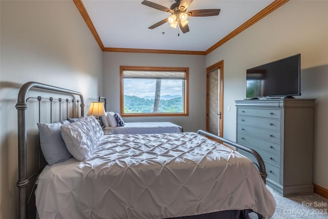 carpeted bedroom with ceiling fan and ornamental molding