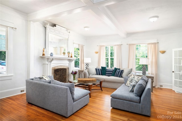 living room featuring crown molding, light hardwood / wood-style flooring, and beamed ceiling