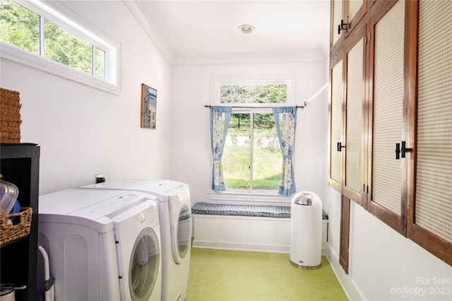 washroom with washing machine and clothes dryer and ornamental molding