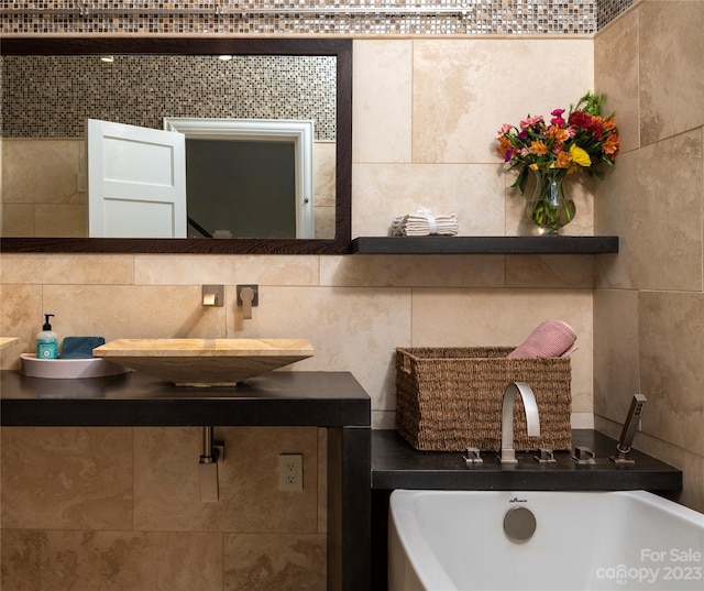 bathroom featuring a bath, tile walls, tasteful backsplash, and vanity