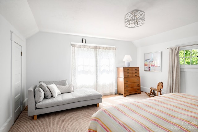 bedroom featuring light colored carpet and vaulted ceiling