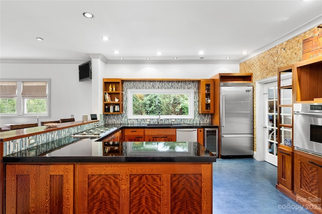 kitchen featuring backsplash, a healthy amount of sunlight, beverage cooler, and stainless steel appliances