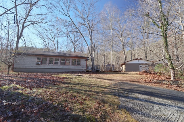 view of front of property featuring a garage and an outbuilding