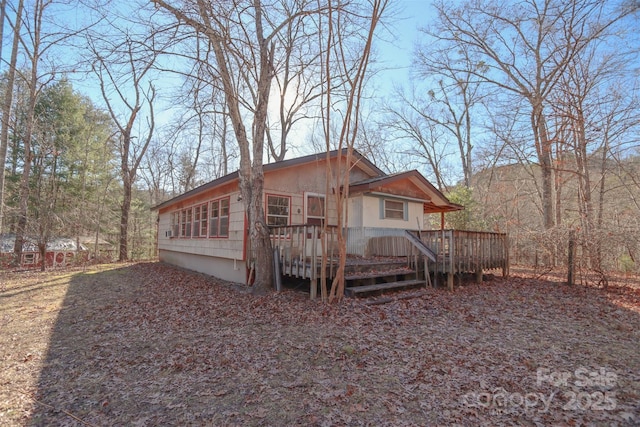 back of property featuring a deck