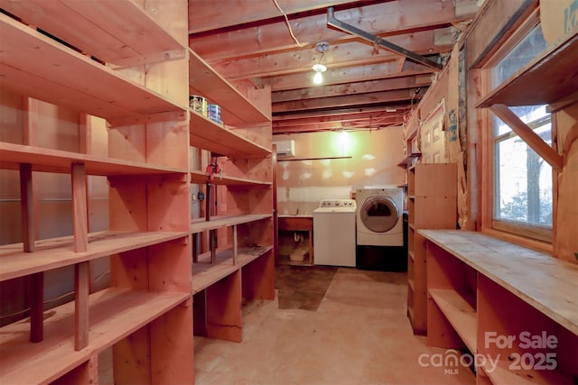 storage room featuring washer and dryer and sink