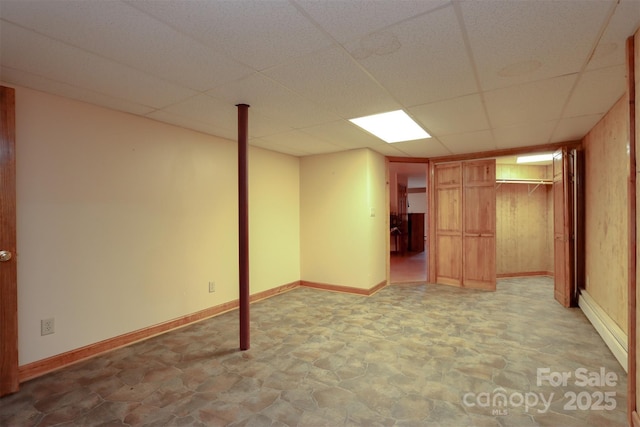 basement featuring a paneled ceiling