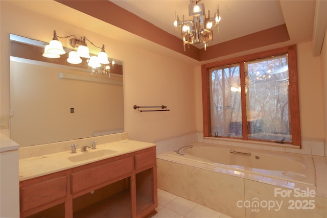 bathroom featuring tile patterned flooring, a relaxing tiled tub, vanity, and an inviting chandelier