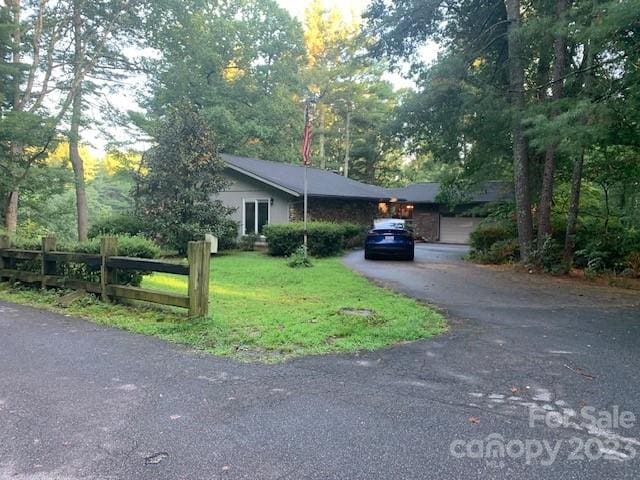 ranch-style home with a front lawn