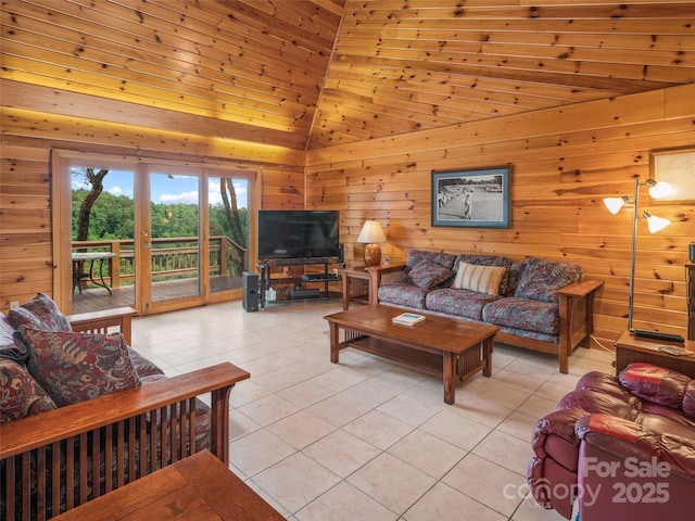 living room with wooden walls, light tile patterned flooring, and high vaulted ceiling