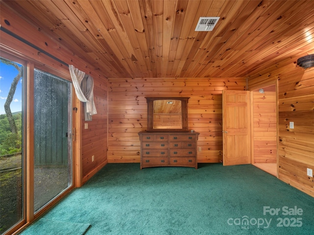 interior space with carpet flooring and wood walls