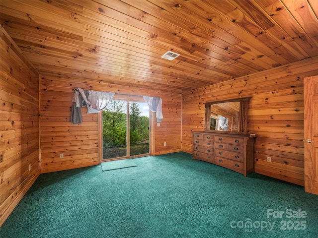 interior space featuring access to exterior, wooden walls, carpet floors, and wood ceiling