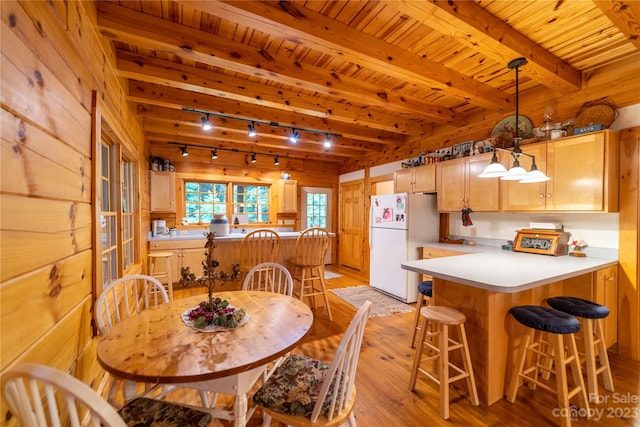 dining area featuring wooden walls, wooden ceiling, and light wood-type flooring