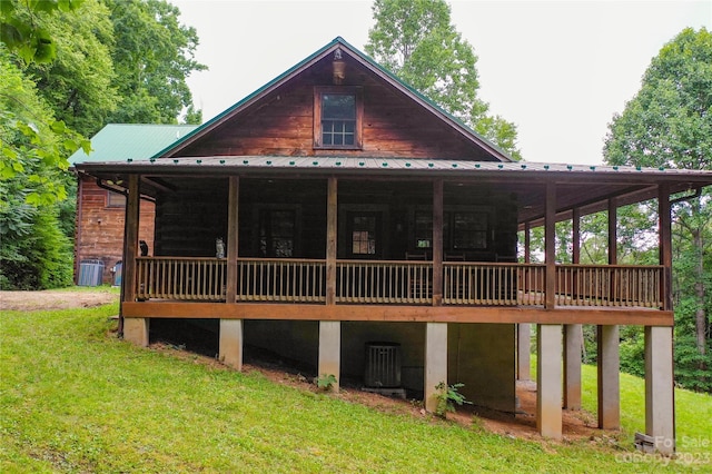 back of property featuring a lawn and central AC unit