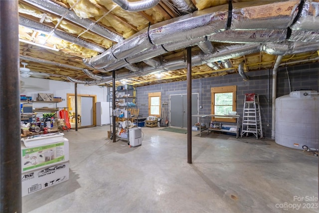 basement featuring white fridge