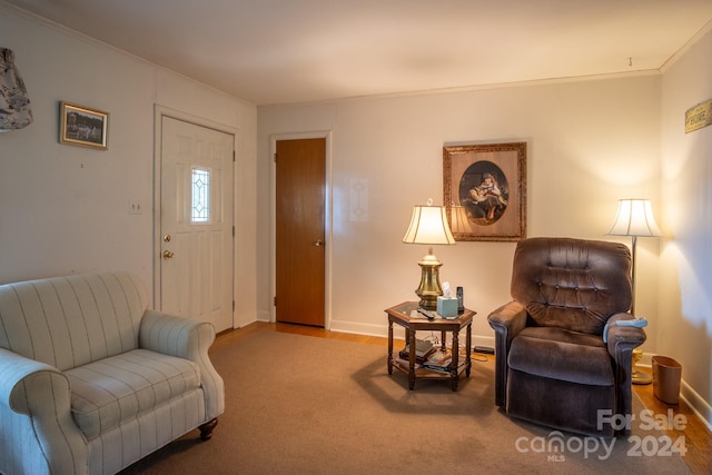 living room featuring crown molding and wood-type flooring