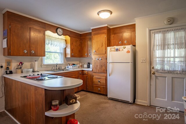 kitchen with kitchen peninsula, white refrigerator, carpet flooring, sink, and electric cooktop