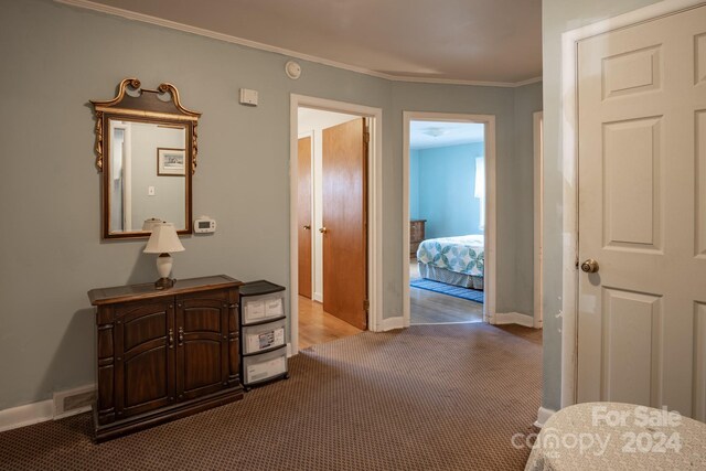 corridor featuring crown molding and dark hardwood / wood-style floors