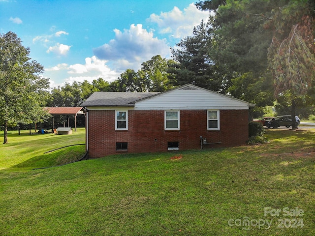 view of side of home featuring a lawn