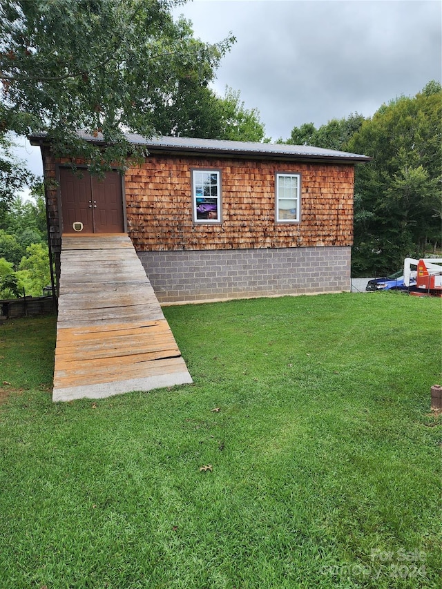 back of house with a lawn