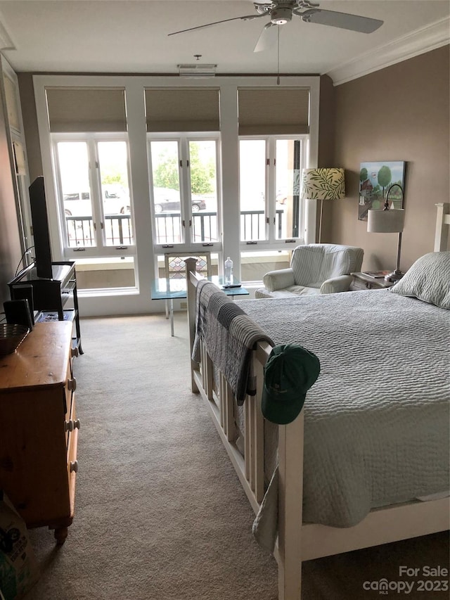 bedroom featuring light carpet, ornamental molding, and ceiling fan