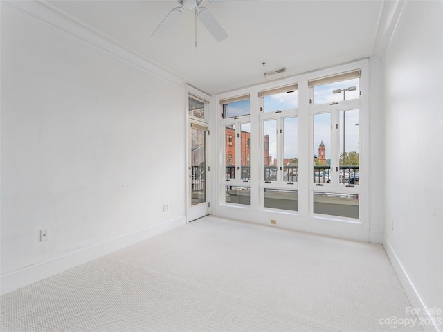 unfurnished room with light carpet, crown molding, and ceiling fan