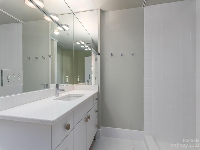 bathroom with tile floors and vanity