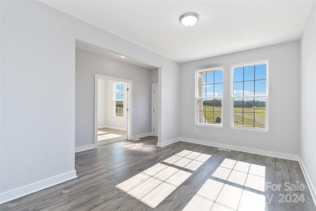 unfurnished room with hardwood / wood-style floors