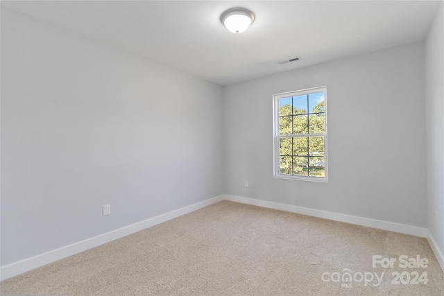 empty room featuring light carpet