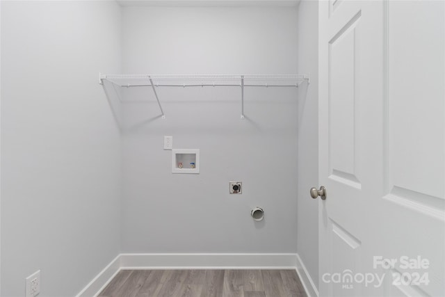 clothes washing area featuring hardwood / wood-style floors, electric dryer hookup, and washer hookup