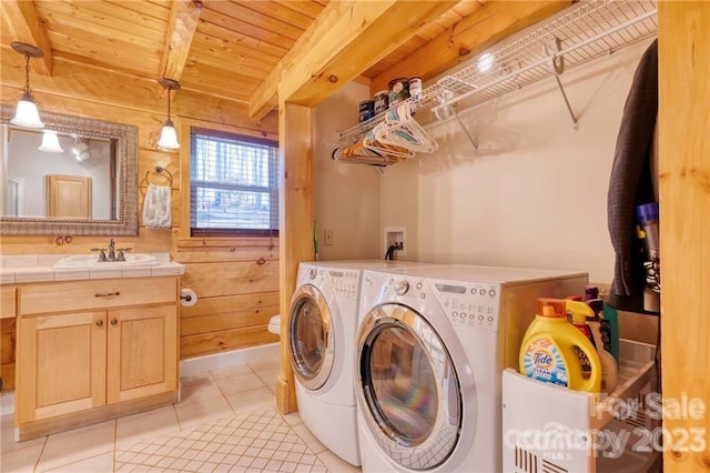 laundry area with sink, hookup for a washing machine, wood ceiling, light tile flooring, and washer and dryer