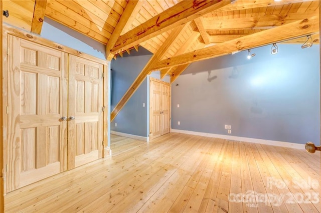 bonus room with light hardwood / wood-style floors, vaulted ceiling with beams, and wood ceiling