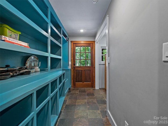 doorway with dark tile floors