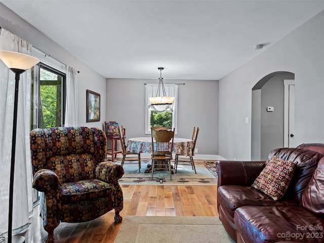 living room with an inviting chandelier and light hardwood / wood-style floors