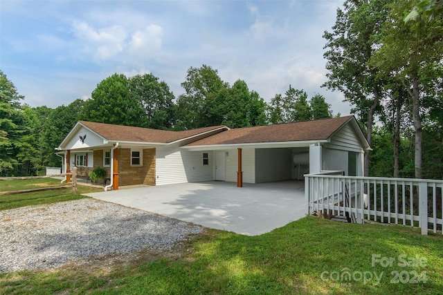 ranch-style house featuring a front yard, a carport, and a porch