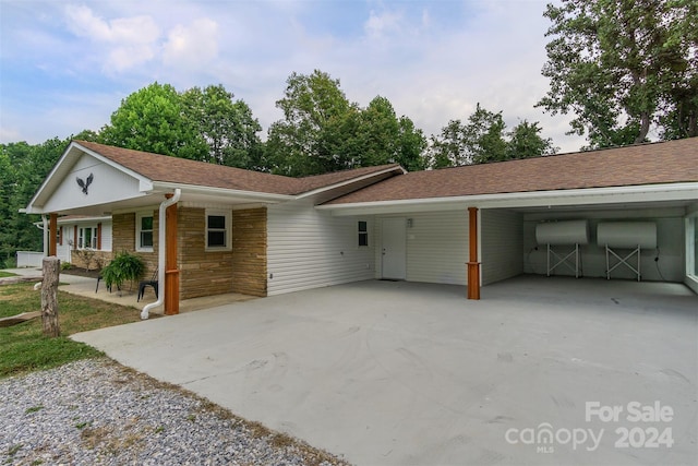 ranch-style house with a carport and a porch