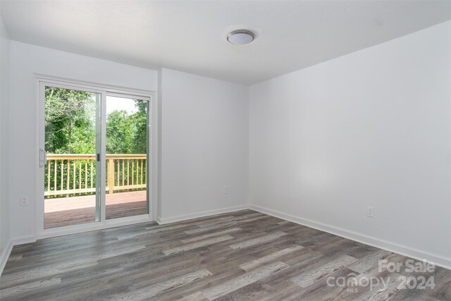 empty room featuring hardwood / wood-style flooring and plenty of natural light