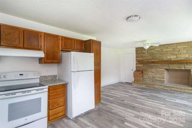 kitchen with ceiling fan, light wood-type flooring, a textured ceiling, and white appliances