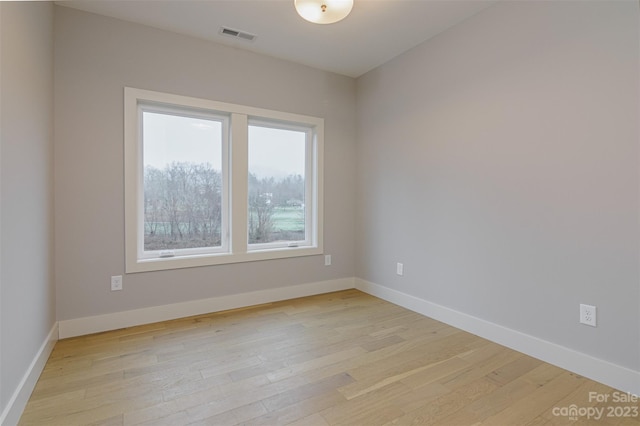 unfurnished room with light hardwood / wood-style floors