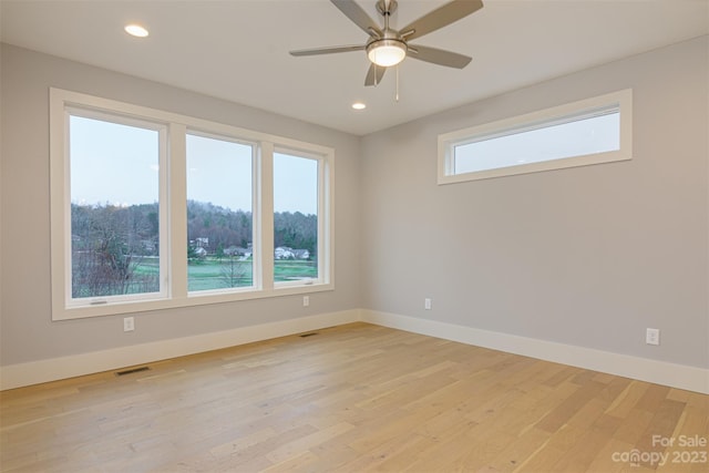 spare room with ceiling fan and light hardwood / wood-style floors