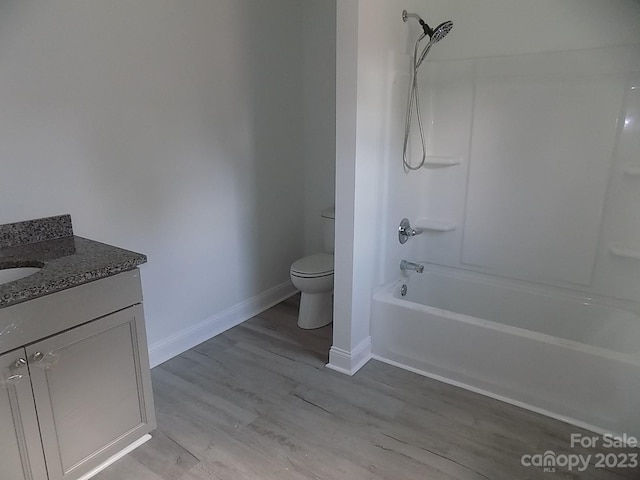 full bathroom featuring shower / bathing tub combination, toilet, hardwood / wood-style floors, and vanity