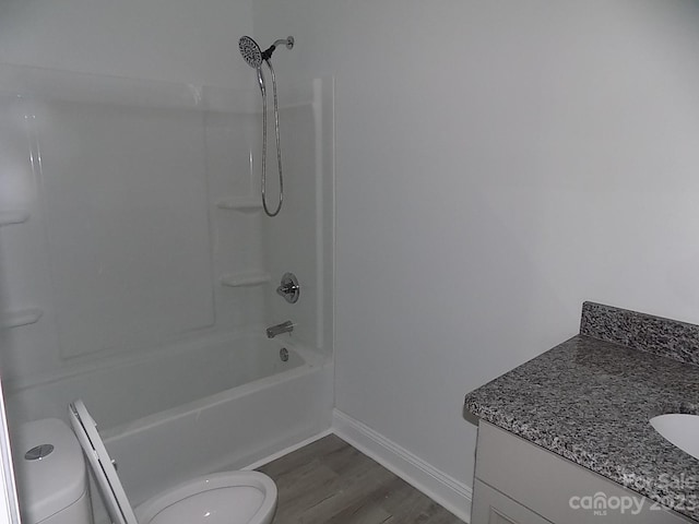 full bathroom featuring bathtub / shower combination, toilet, vanity, and hardwood / wood-style flooring