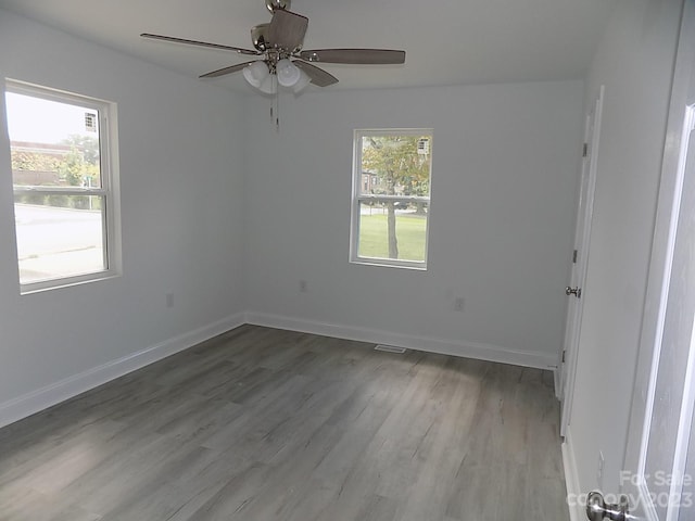 unfurnished room featuring ceiling fan and dark hardwood / wood-style flooring