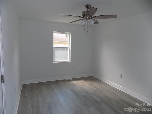 empty room featuring ceiling fan and wood-type flooring