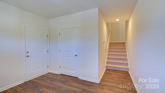 hallway with dark wood-type flooring