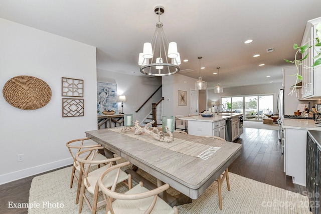 dining space featuring a chandelier, dark hardwood / wood-style floors, and sink