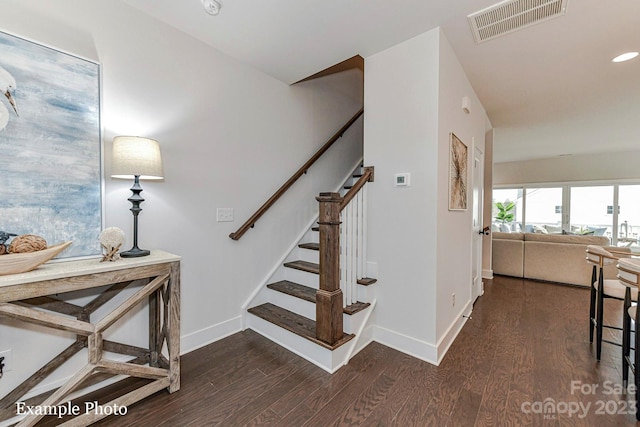 stairs featuring dark hardwood / wood-style flooring